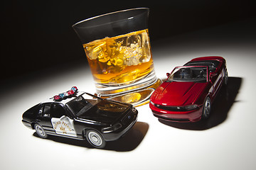 Image showing Police and Sports Car Next to Alcoholic Drink