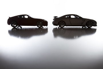 Image showing Silhouette of Sports Cars on Reflective Surface 
