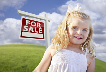 Image showing Smiling Cute Girl in Field with For Sale Real Estate Sign