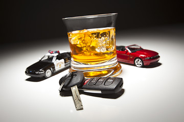 Image showing Highway Patrol Police and Sports Car Next to Alcoholic Drink and