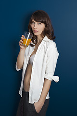 Image showing Beautiful woman drinking orange juice