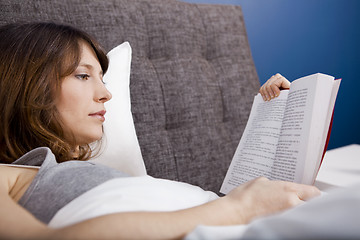 Image showing Young girl reading a book