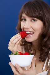 Image showing Eating strawberries