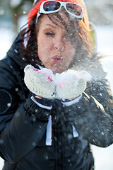 Image showing Woman blowing snow