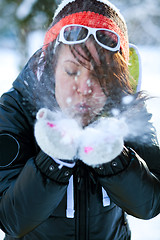 Image showing Woman blowing snow