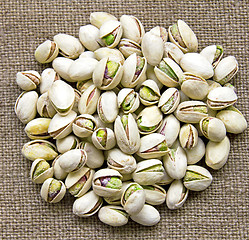 Image showing Delicious pistachios on sackcloth background