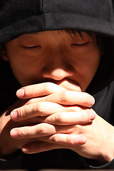 Image showing Closeup portrait of a young man praying to god