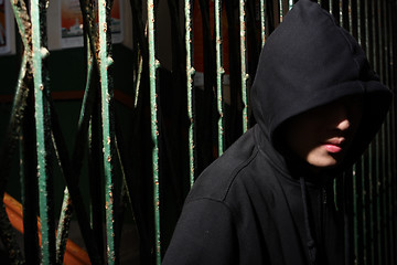 Image showing man in hood at night, want to break the shutter