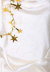 Image showing Golden stars on white silk