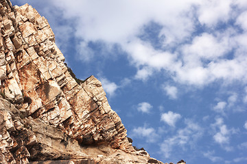 Image showing Big rock under blue clouded sky