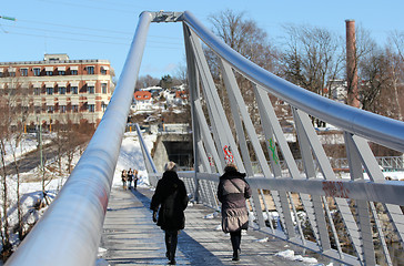 Image showing People walking on the bridge.