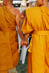 Image showing Monks holding hands