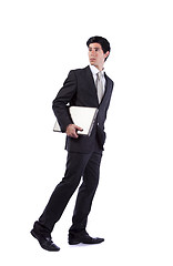 Image showing Businessman walking and looking back