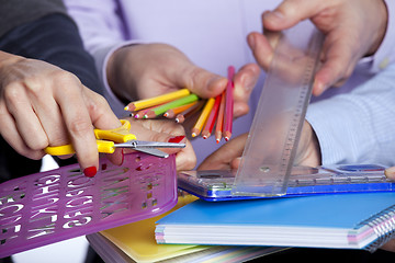 Image showing Hands holding education objects