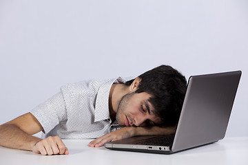 Image showing Exhausted man sleeping at his office