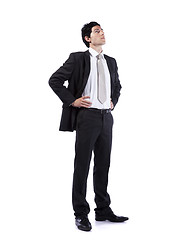 Image showing Powerful businessman looking up
