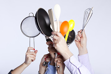 Image showing Hands holding kitchenware tools