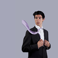 Image showing Businessman looking to his flying necktie