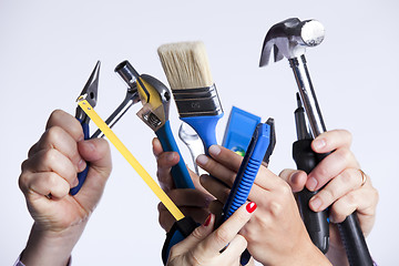 Image showing Hands with tools
