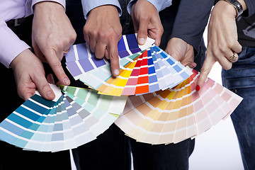 Image showing Hands pointing to color samples