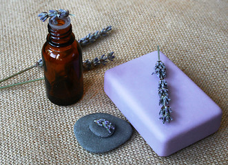 Image showing Lavender flowers, bottle of essential oil and soap in a spa comp