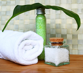 Image showing White bath towel, bottle of sea salt in spa composition