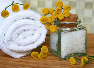 Image showing White bath towel, bottle of sea salt in spa composition