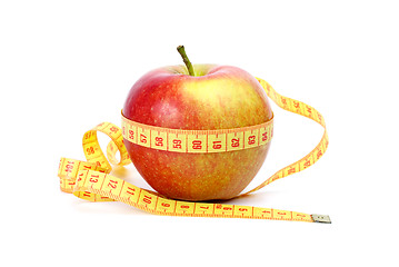 Image showing Yellow-red apple and measurement tape