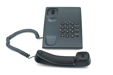 Image showing Black phone with handset near