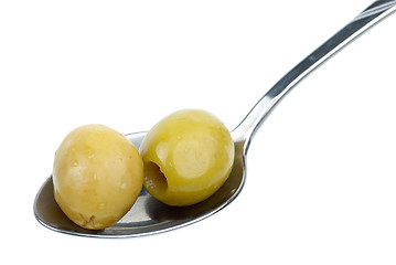 Image showing Two marinated pitted green olives in the small metal spoon