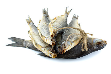 Image showing Five dried sea roach fishes on the rope and bream fish