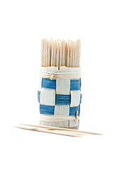 Image showing Bundle of wooden toothpicks and some toothpicks near