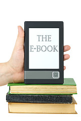 Image showing Hand put e-book reader on top of classic paper books