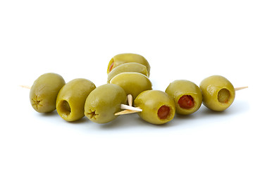 Image showing Some olives stuffed with pepper on a wooden toothpicks