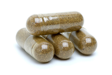 Image showing Four brown homeopathic pills