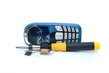 Image showing Broken mobile phone, screwdriver and microchips