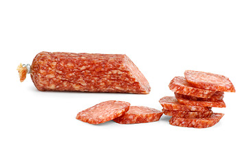 Image showing Half of salami sausage and slices near