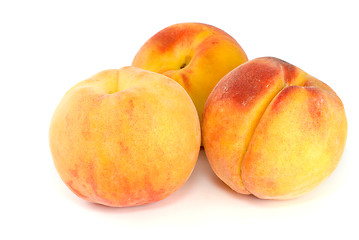 Image showing Three orange peaches