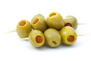 Image showing Some olives stuffed with pepper on a wooden toothpicks