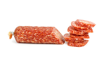 Image showing Half of salami sausage and pile of slices near