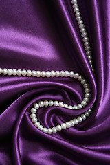 Image showing White pearls on a lilac silk 