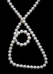 Image showing White pearls on the black velvet 