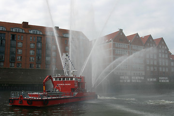 Image showing Fireboat flush in the air.