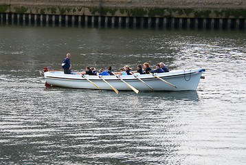 Image showing People in a rowboat.