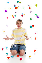 Image showing Happy boy with easter eggs falling