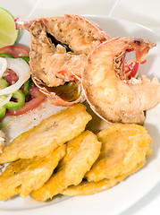 Image showing Caribbean lobster tail dinner with tostones rice salad
