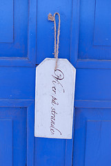 Image showing sign on blue door