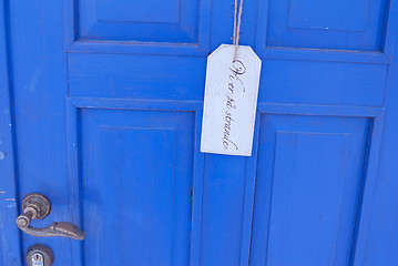 Image showing sign on blue door