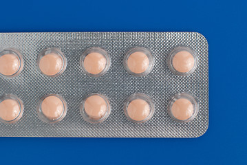 Image showing Close-up of a pack of orange pills 