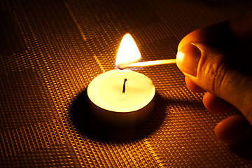 Image showing Candle ignition with match